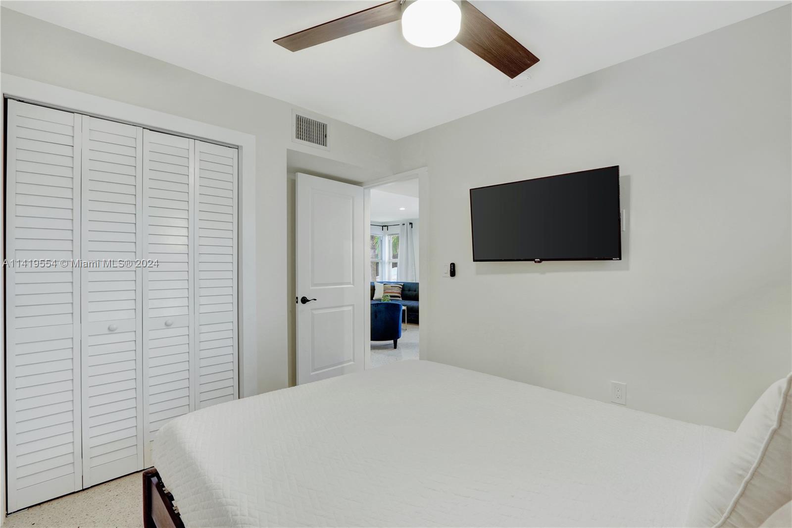 Palm Trail Delray Beach, FL 33483 - Photo 35 of 55 a bedroom with a bed and a flat screen tv