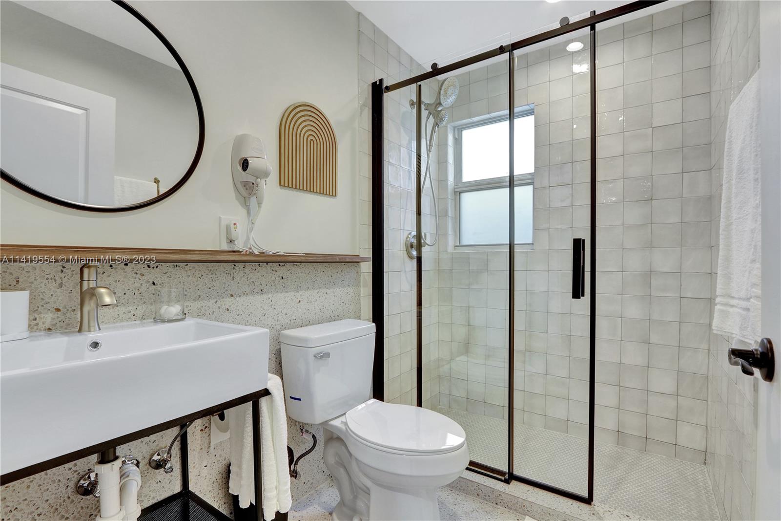 Palm Trail Delray Beach, FL 33483 - Photo 36 of 55 a bathroom with a toilet sink and mirror