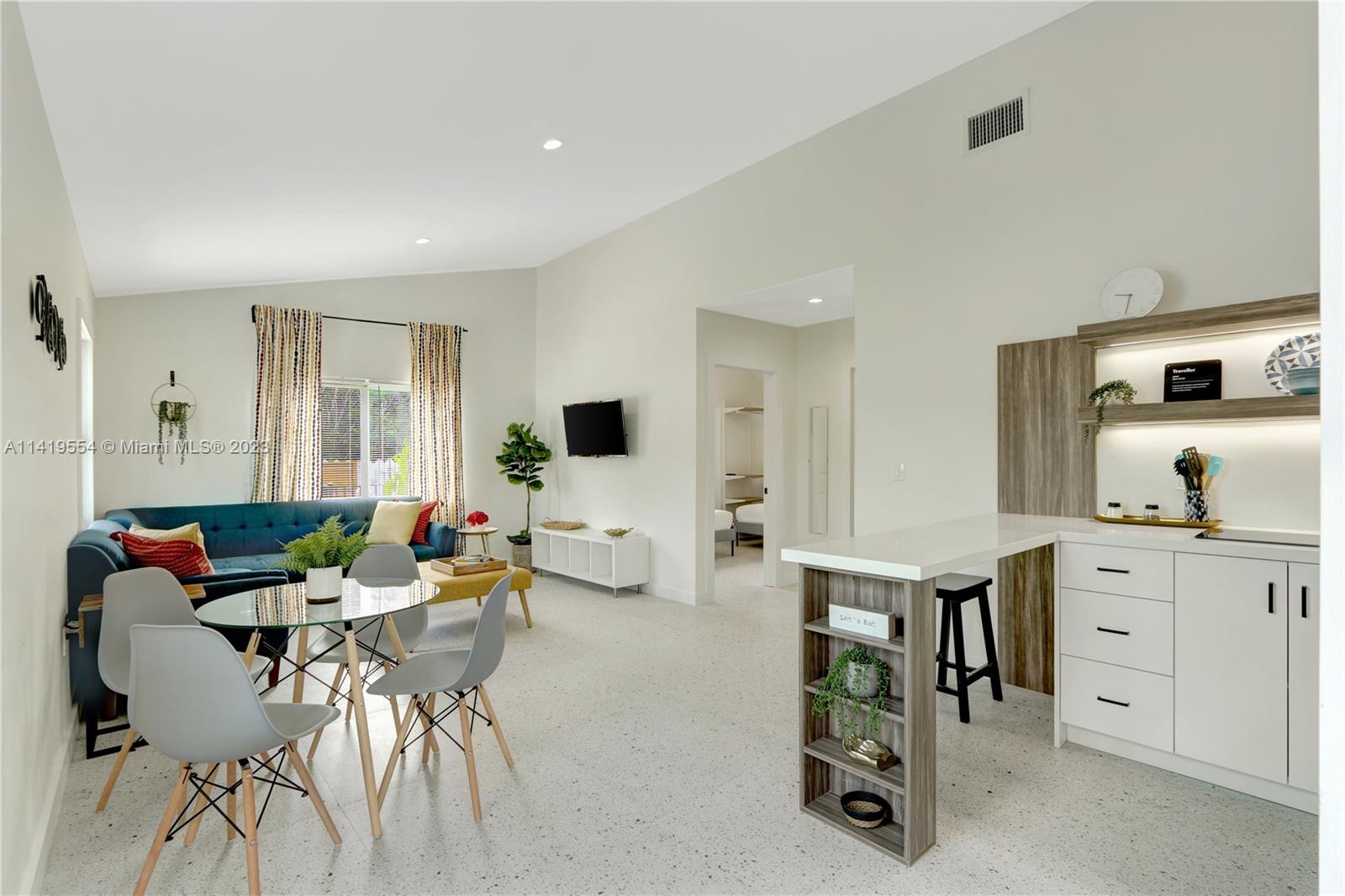 Palm Trail Delray Beach, FL 33483 - Photo 38 of 55 a living room with furniture and a flat screen tv