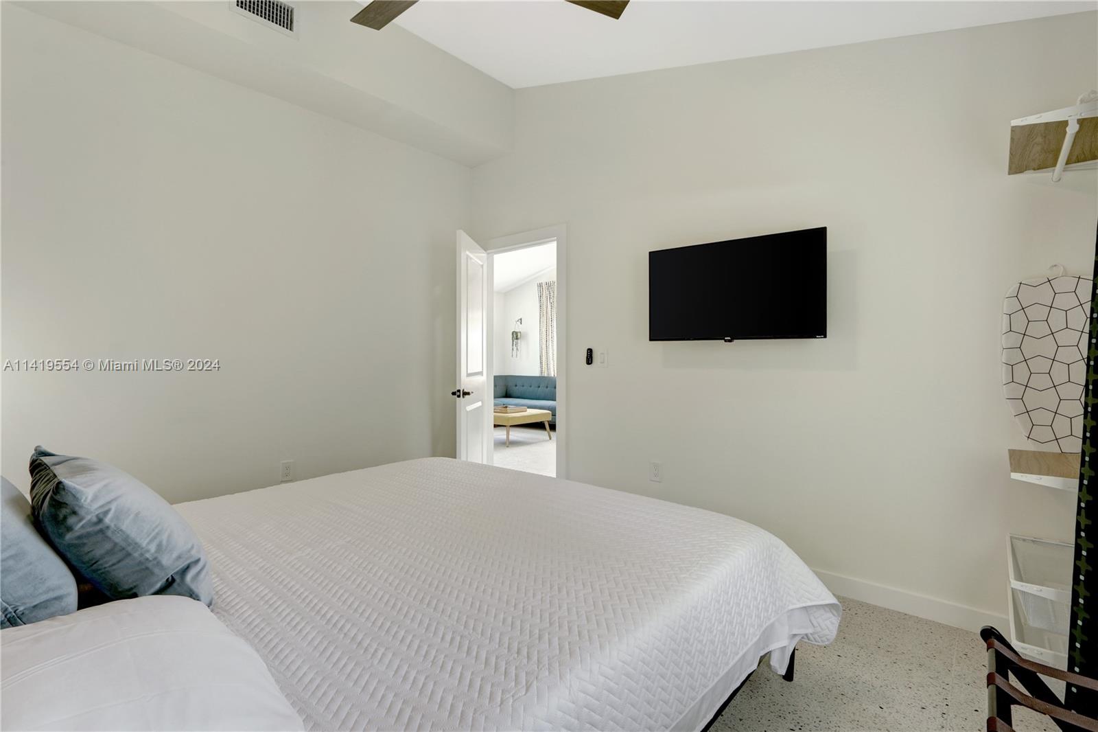 Palm Trail Delray Beach, FL 33483 - Photo 39 of 55 a bedroom with a bed and a flat screen tv
