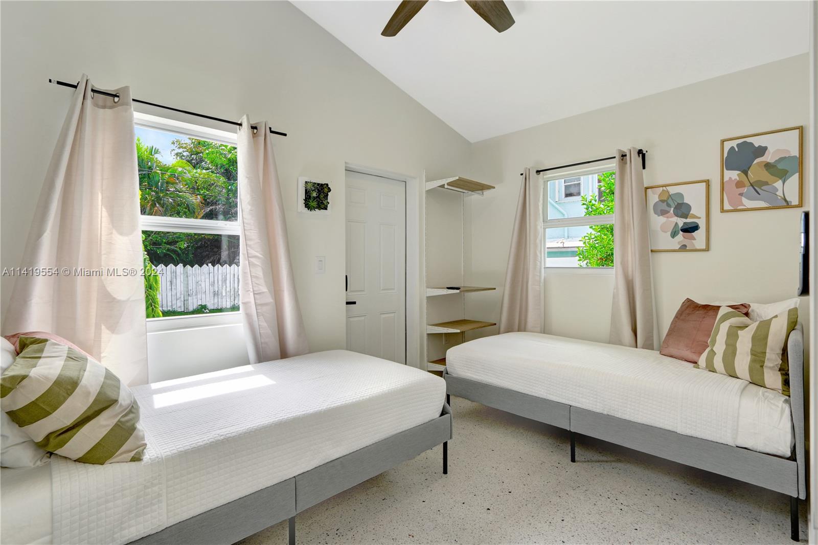 Palm Trail Delray Beach, FL 33483 - Photo 40 of 55 a bedroom with a bed a window and painting on the wall