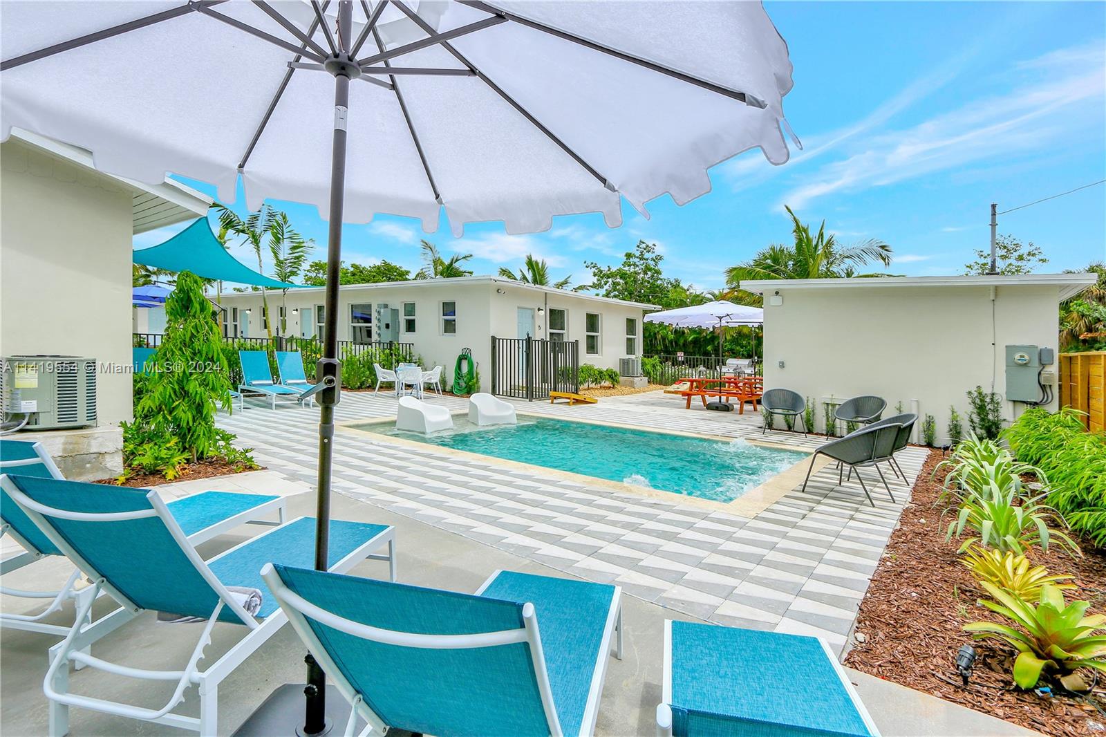 Palm Trail Delray Beach, FL 33483 - Photo 4 of 55 a view of a patio with table and chairs under an umbrella