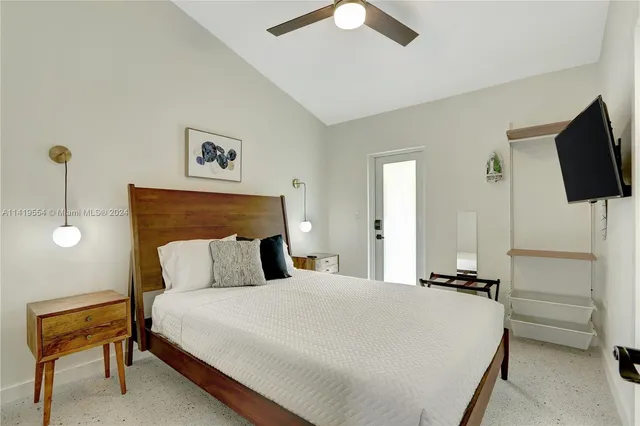 a bedroom with a bed and a television