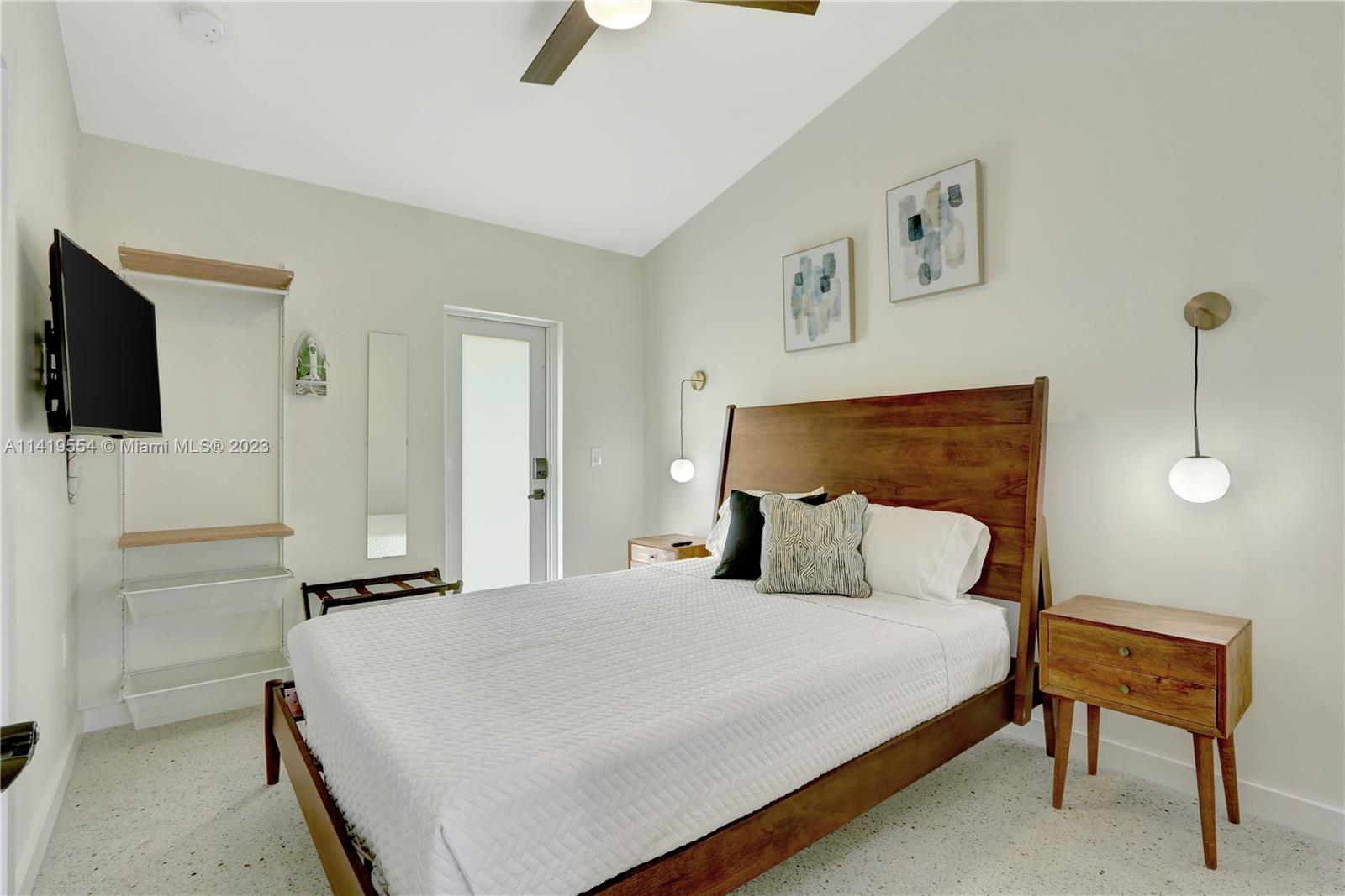 Palm Trail Delray Beach, FL 33483 - Photo 48 of 55 a bedroom with a bed and a television