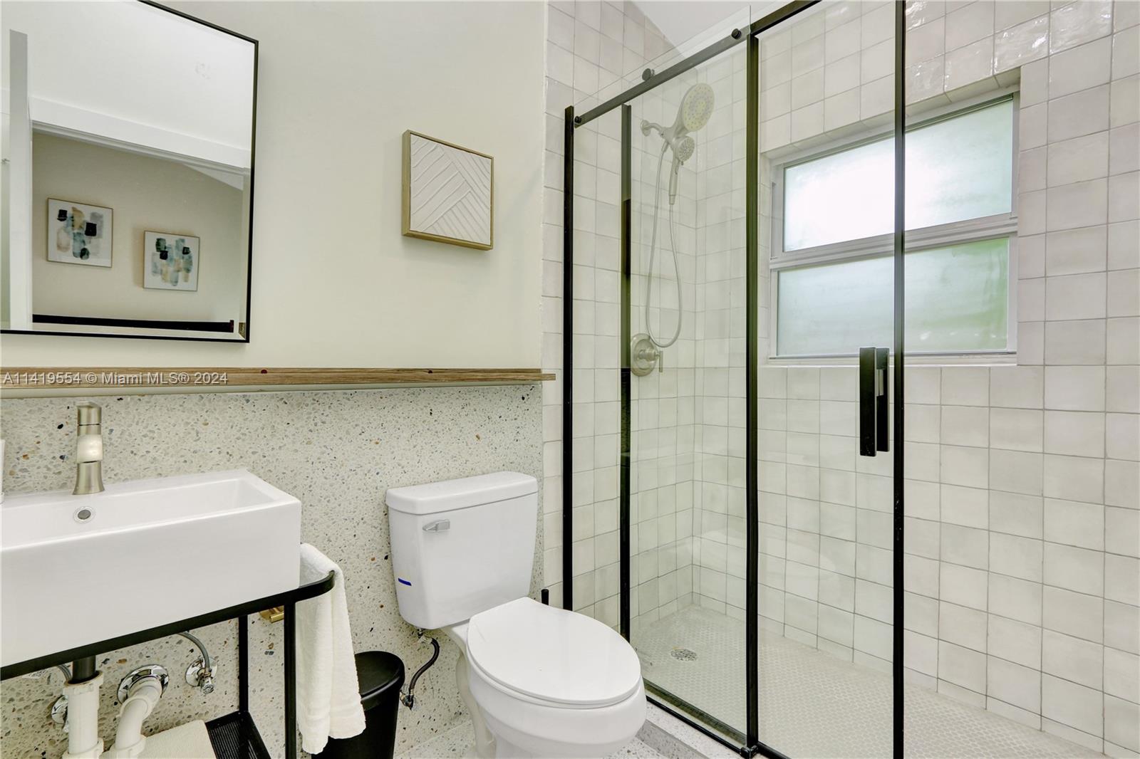 Palm Trail Delray Beach, FL 33483 - Photo 49 of 55 a bathroom with a toilet a sink and shower