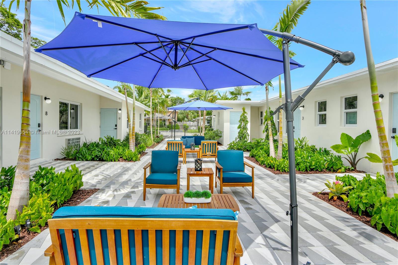 Palm Trail Delray Beach, FL 33483 - Photo 5 of 55 a view of a patio with chairs and an umbrella