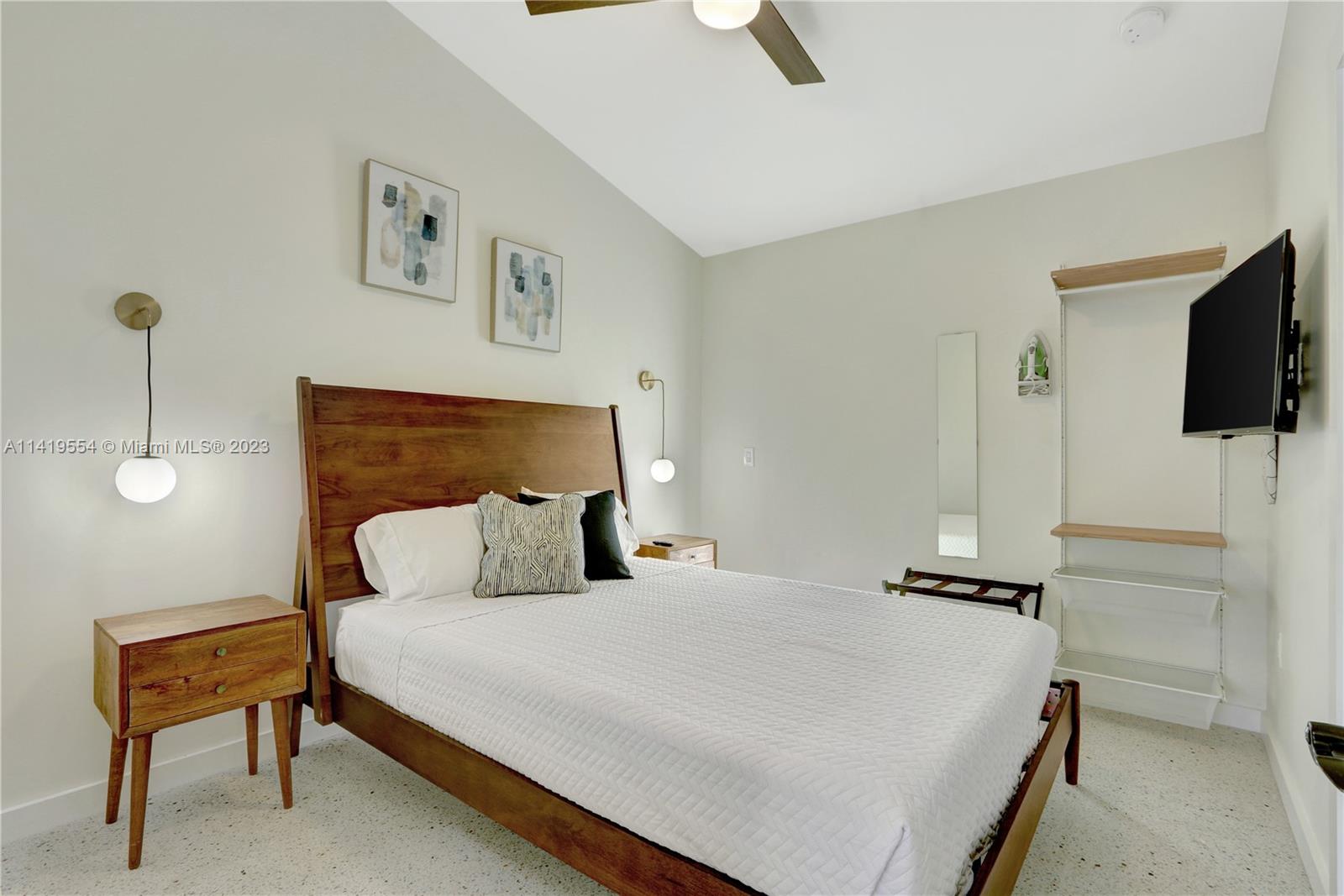 Palm Trail Delray Beach, FL 33483 - Photo 53 of 55 a bedroom with a bed and a flat screen tv