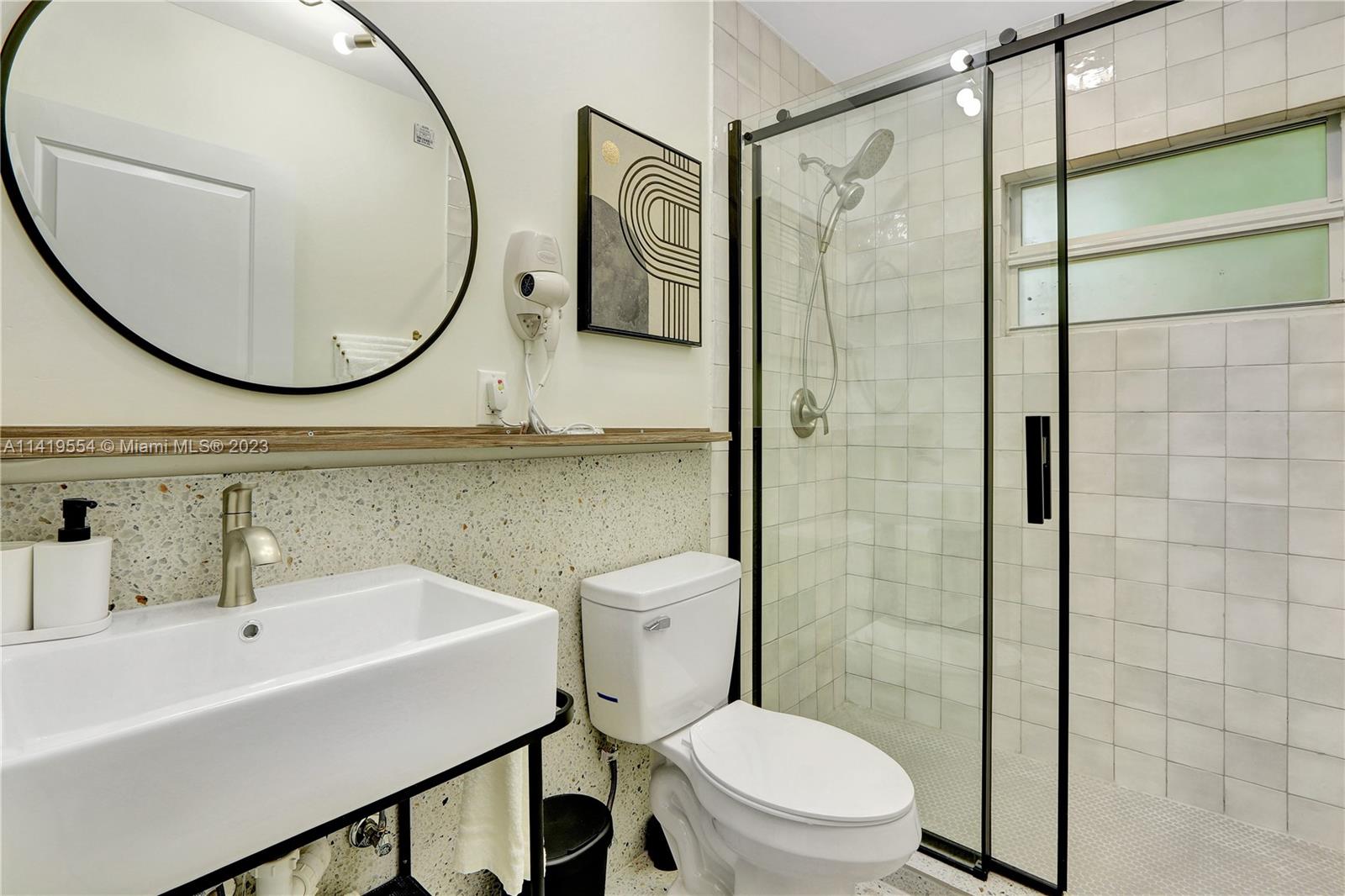 Palm Trail Delray Beach, FL 33483 - Photo 55 of 55 a bathroom with a sink a toilet and a mirror