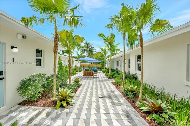 a backyard of a house with table and chairs