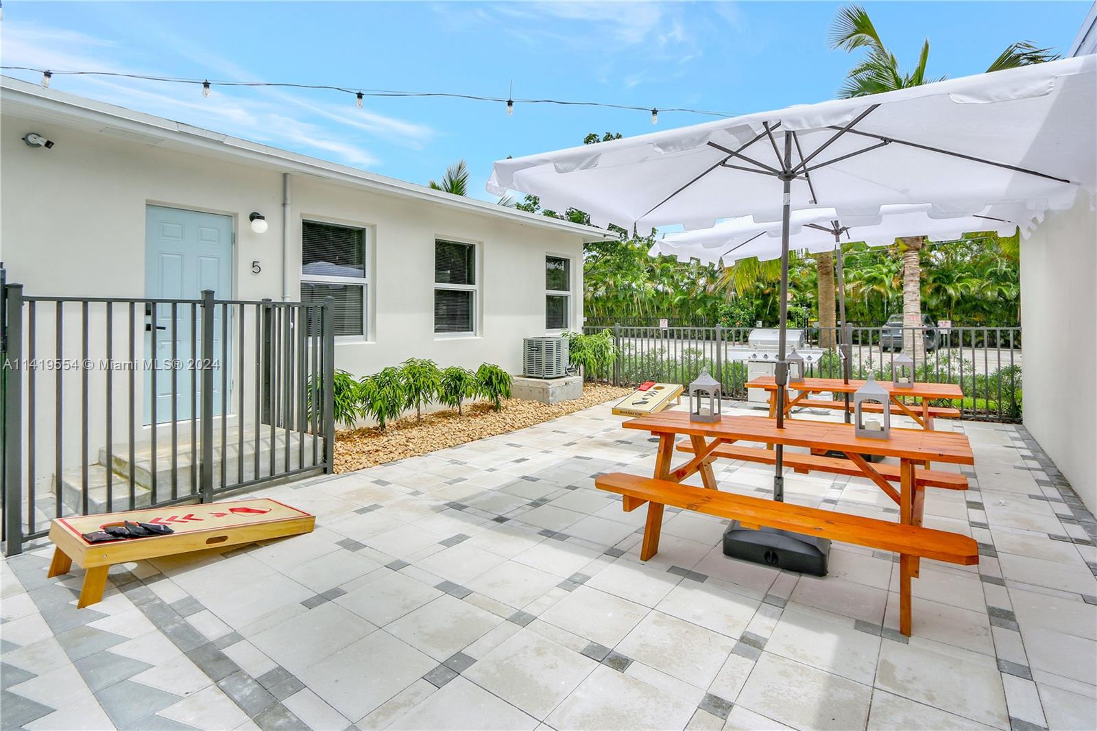 Palm Trail Delray Beach, FL 33483 - Photo 7 of 55 a backyard of a house with table and chairs