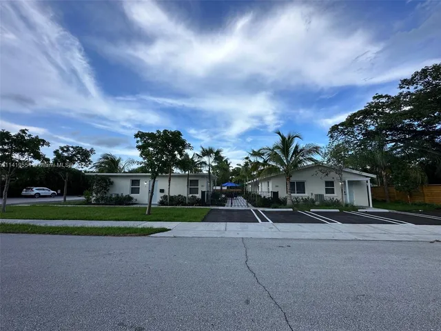 a view of street with houses and trees in the background