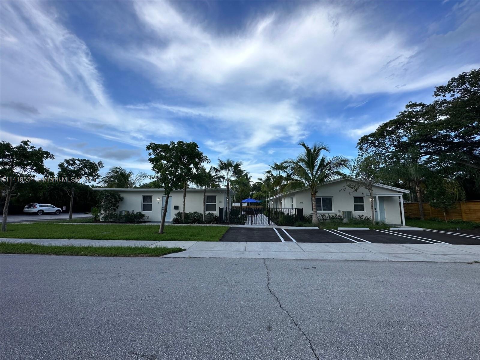 Palm Trail Delray Beach, FL 33483 - Photo 8 of 55 a front view of a house with a yard and trees