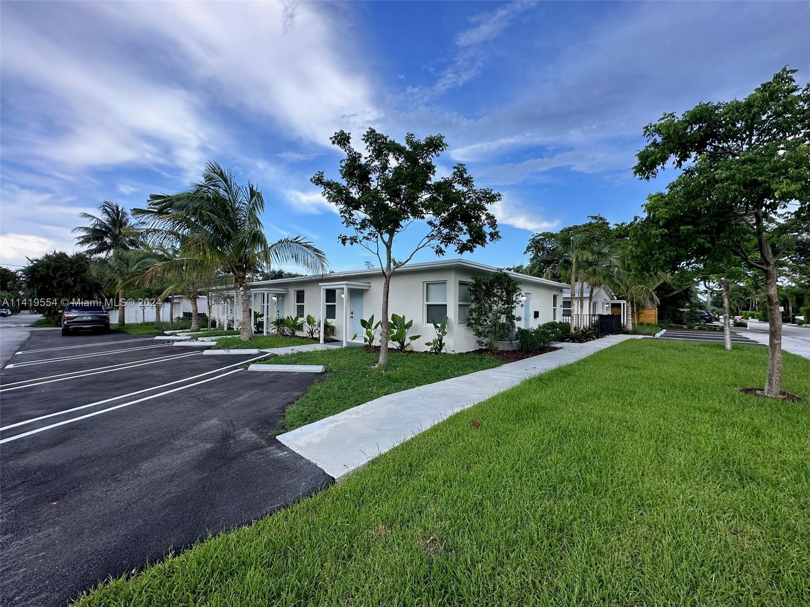 Palm Trail Delray Beach, FL 33483 - Photo 10 of 55 a view of street with houses and trees in the background