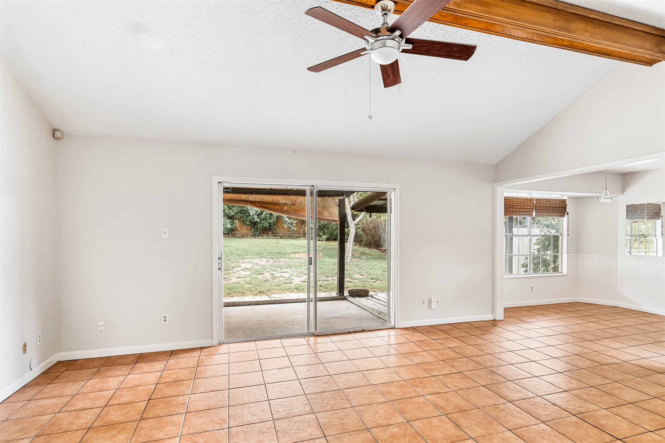 7506 Glenhill Road Austin, TX 78752 - Photo 2 of 24 Natural light floods this living area, offering a seamless transition to the outdoors through sliding glass doors.