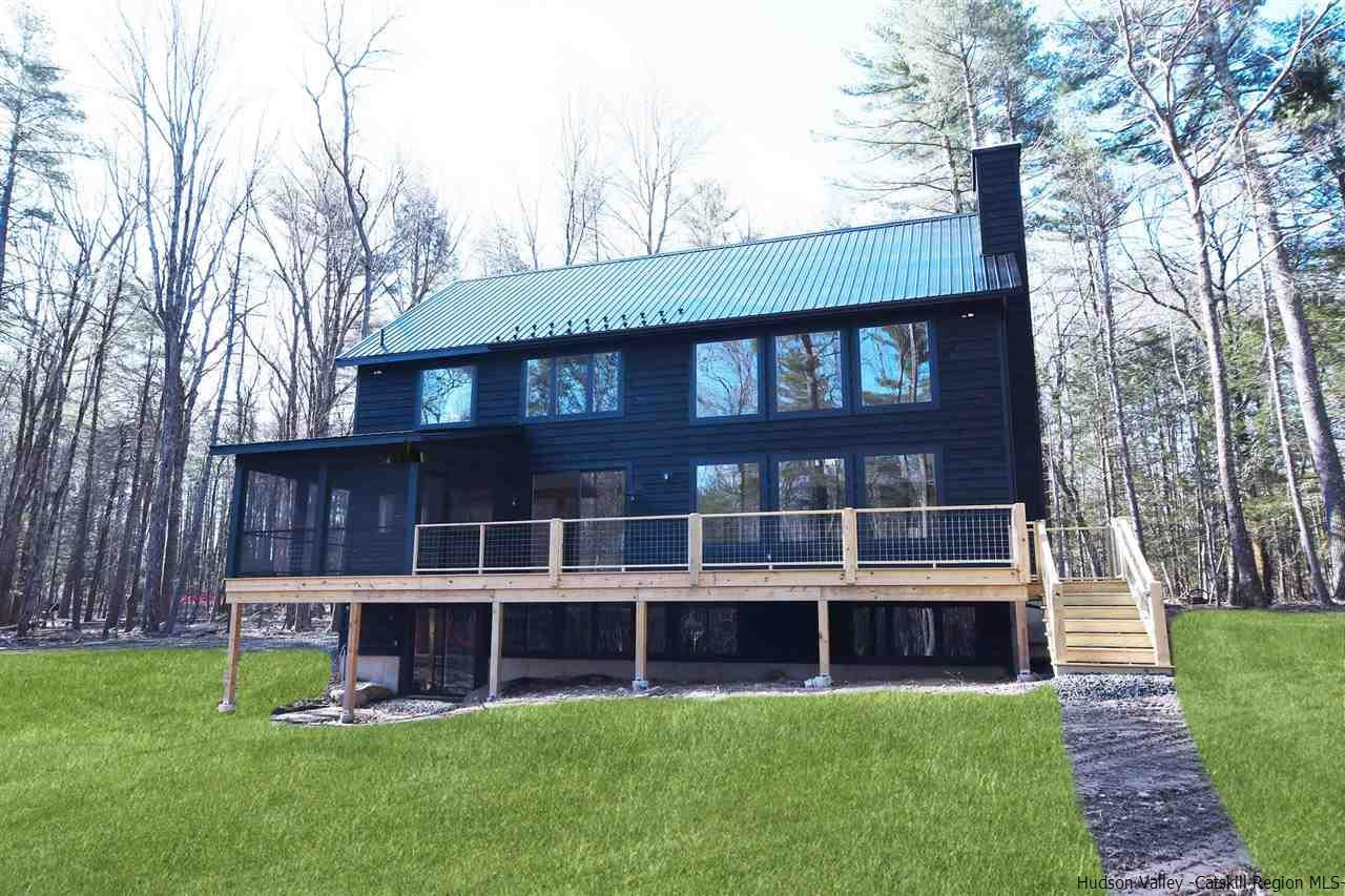 a view of a large building with a big yard and large trees