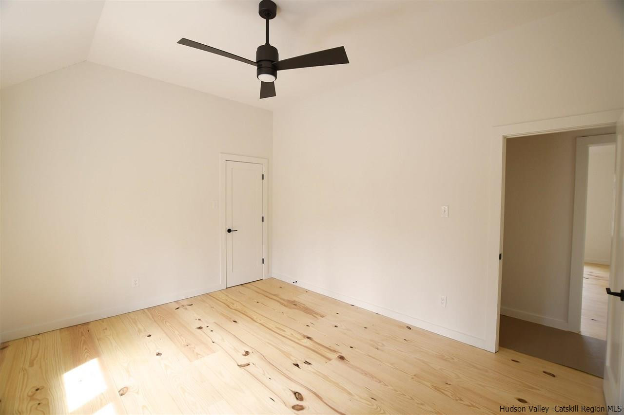 44 Krom Road Olivebridge, NY 12461 - Photo 17 of 33 a view of a big room with wooden floor and a ceiling fan