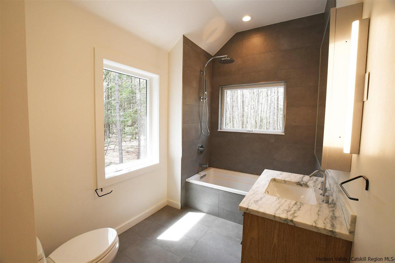 44 Krom Road Olivebridge, NY 12461 - Photo 20 of 33 a bathroom with a tub sink and mirror