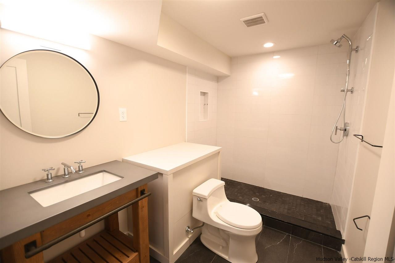 44 Krom Road Olivebridge, NY 12461 - Photo 26 of 33 a bathroom with a sink a toilet and a mirror