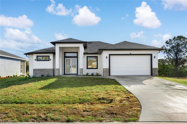 a view of a house with a yard and garage