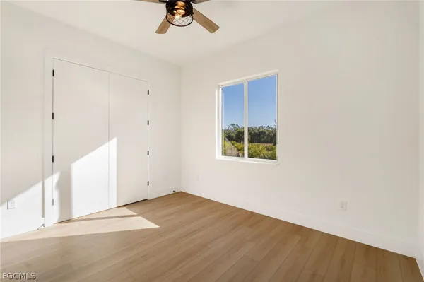 a view of a room with wooden floor and window