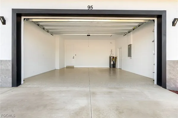 a view of an empty room with a floor to ceiling window and a tree