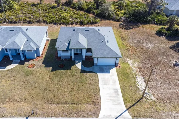 an aerial view of house with yard