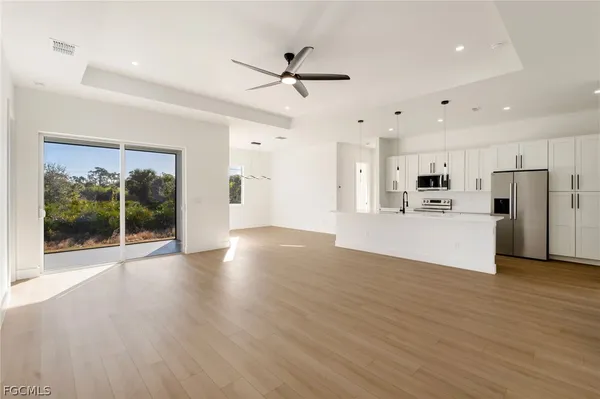 a view of kitchen with cabinets and wooden floor