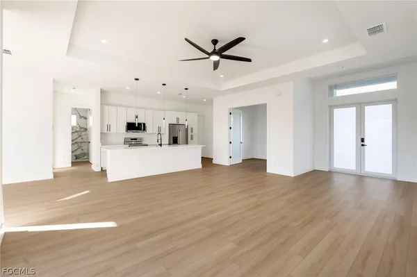 a view of a kitchen with a sink stainless steel appliances and cabinets