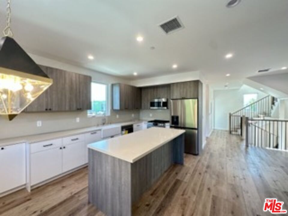 4805 Matilija Avenue Sherman Oaks, CA 91423 - Photo 11 of 22 a kitchen with a sink a counter top space stainless steel appliances and a window
