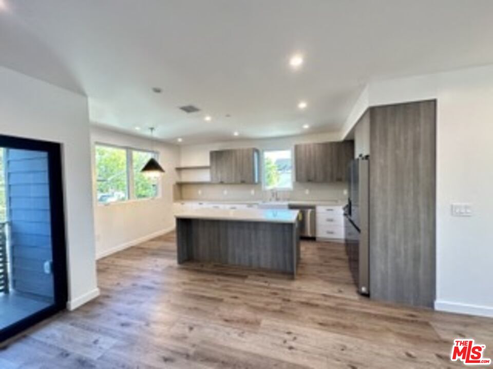 4805 Matilija Avenue Sherman Oaks, CA 91423 - Photo 12 of 22 a view of kitchen with kitchen island wooden floor center island and stainless steel appliances