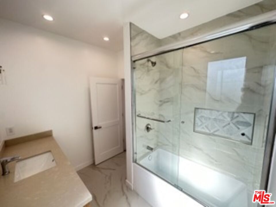 4805 Matilija Avenue Sherman Oaks, CA 91423 - Photo 14 of 22 a bathroom with a bathtub and a shower