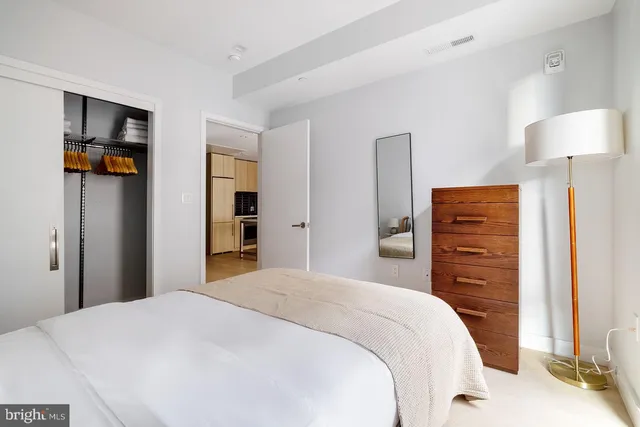 a bedroom with a bed and a mirror