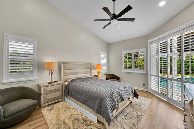 a bedroom with a bed and a large window