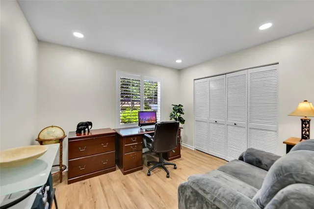 a view of a workspace with furniture and a window