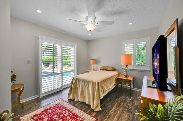 a bedroom with a bed and a flat tv screen on dresser
