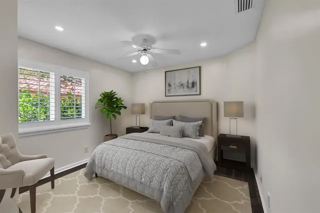 a bedroom with a large bed and a chandelier