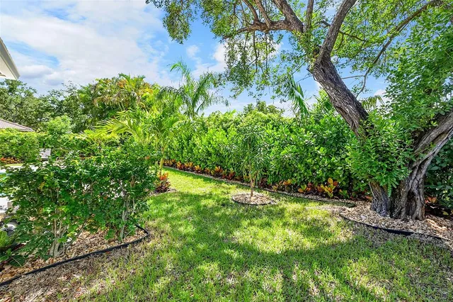 a backyard of a house with lots of green space and garden