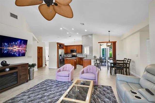 a living room with furniture kitchen view and a rug