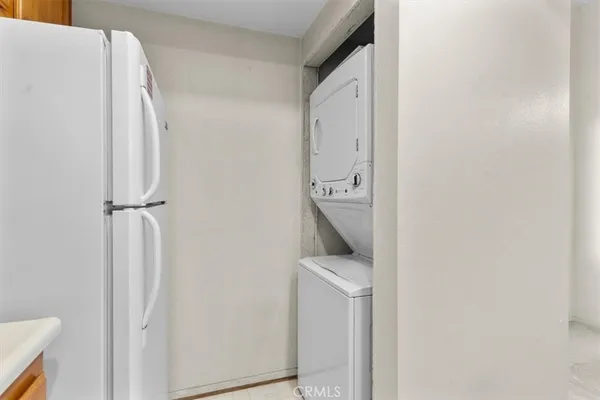 a kitchen with stainless steel appliances granite countertop a stove a sink and a refrigerator with wooden floor