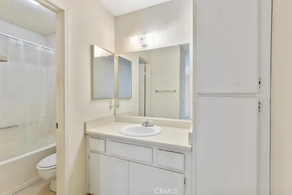 a bathroom with a shower curtain and a window