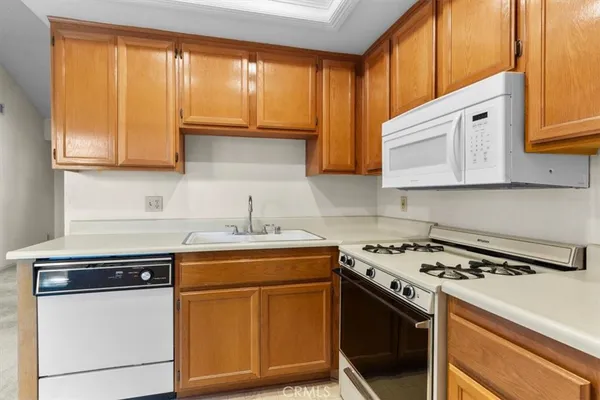 a kitchen with a refrigerator sink and cabinets