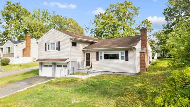 a view of house with backyard and garden