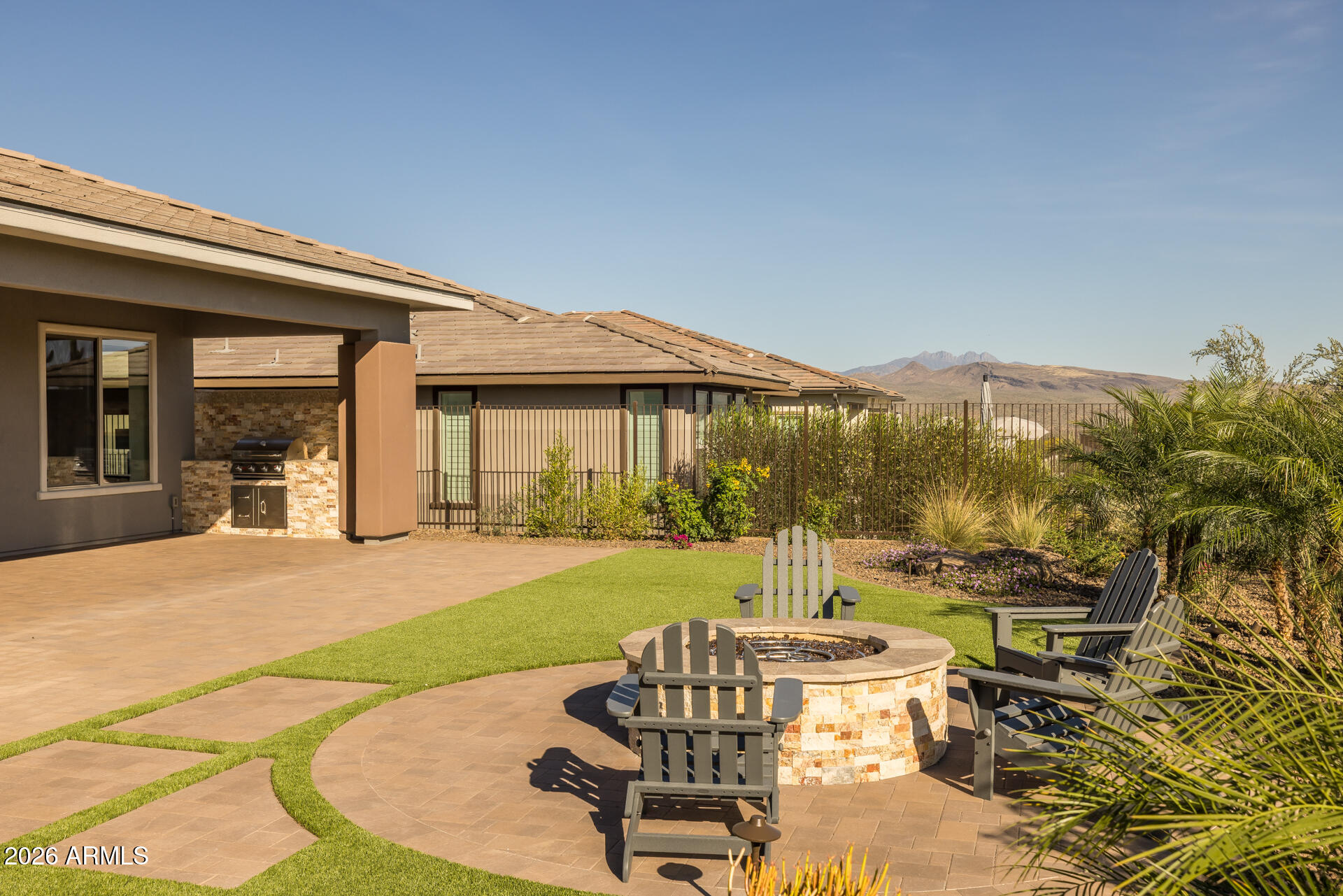 18205 East Juniper Oaks Drive Rio Verde, AZ 85263 - Photo 48 of 77 a view of a patio with table and chairs potted plants and floor to ceiling window