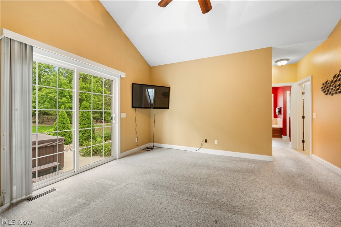 3356 Huntcliffe Road Northeast Canton, OH 44721 - Photo 33 of 50 Spare room with high vaulted ceiling, light carpet, and ceiling fan
