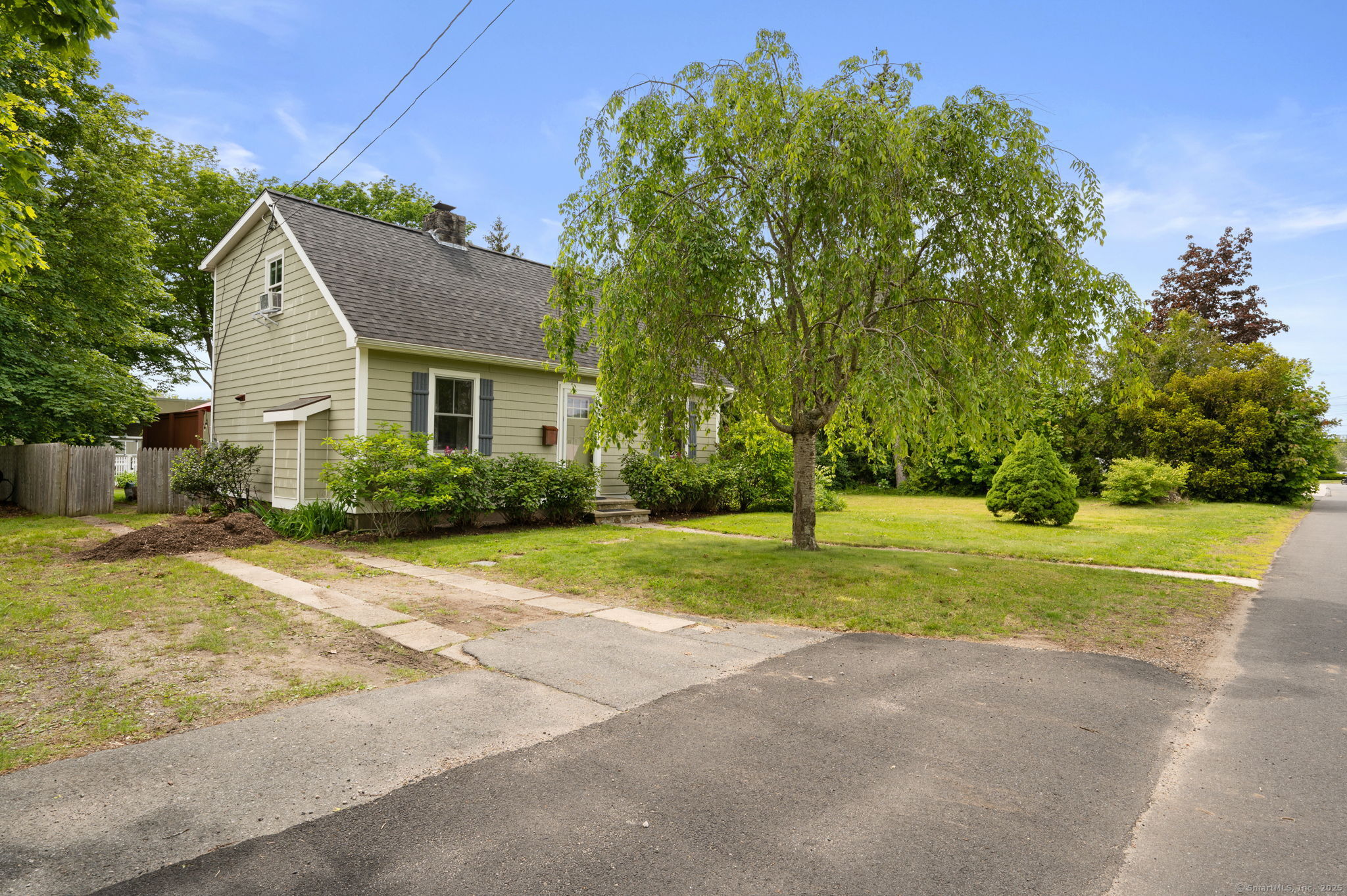 a view of backyard of house with green space