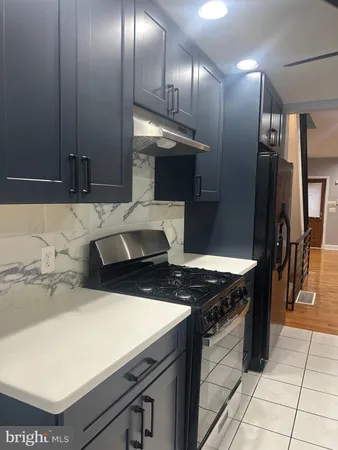 a kitchen with granite countertop a stove and a refrigerator