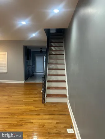 a view of a room with white walls and stairs