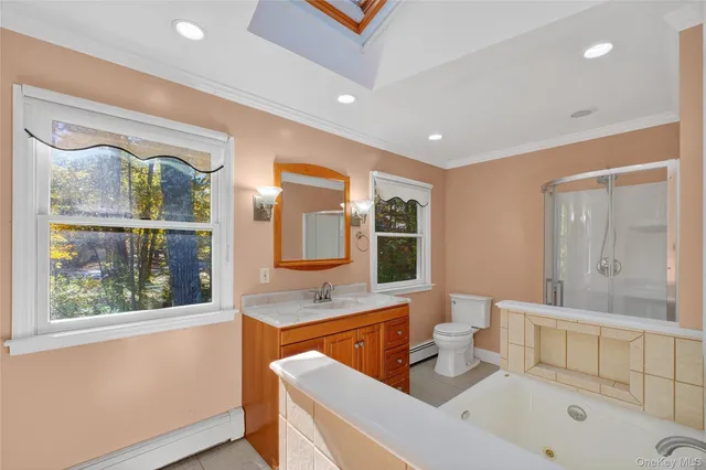 a bathroom with a tub sitting next to a window