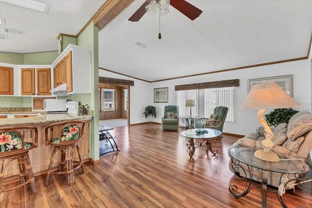 a open kitchen with stainless steel appliances granite countertop a refrigerator and a stove top oven