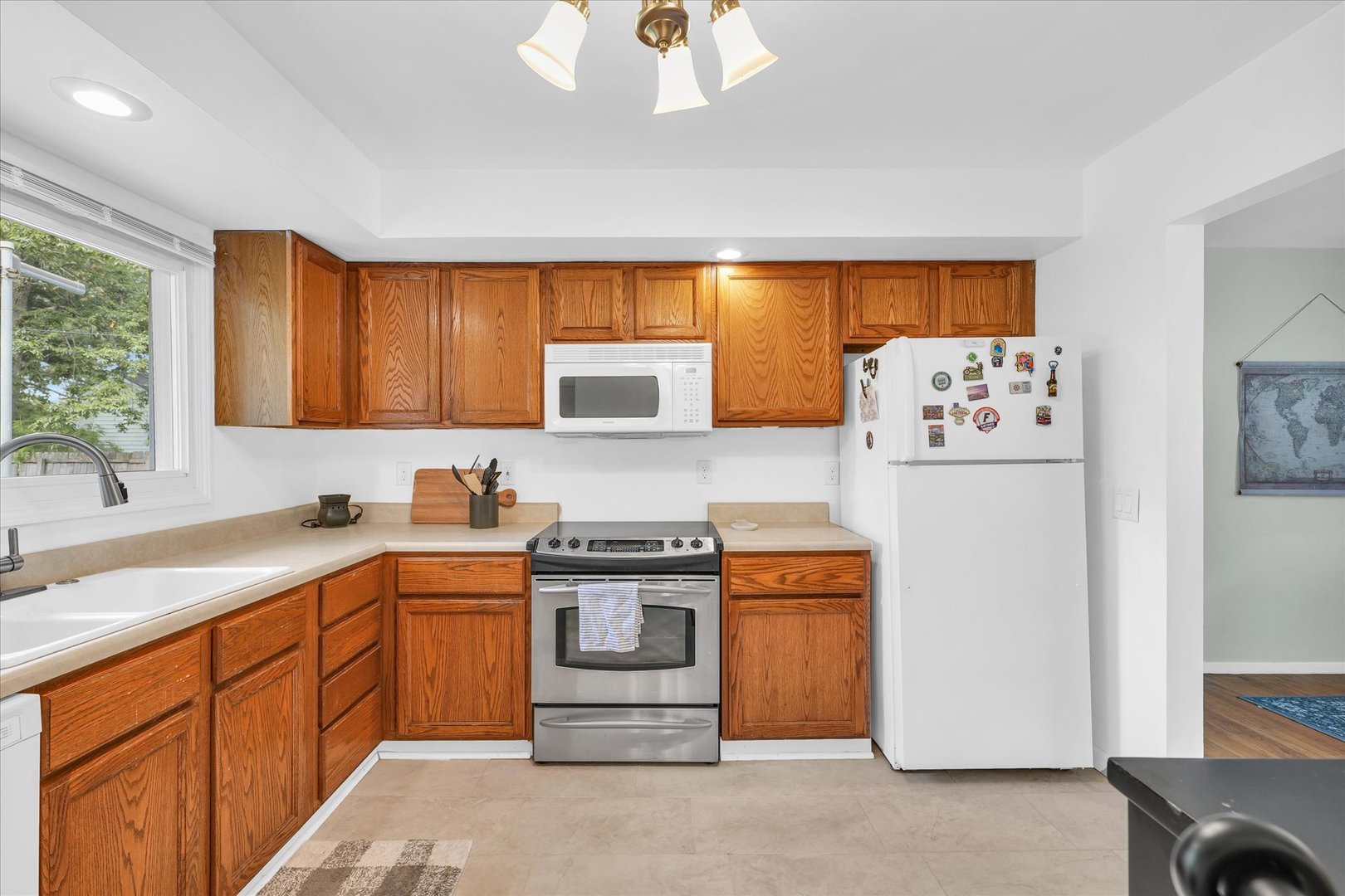 1617 Cornell Drive Champaign, IL 61821 - Photo 11 of 31 a kitchen with stainless steel appliances granite countertop a refrigerator a sink dishwasher a stove with white cabinets and wooden floor